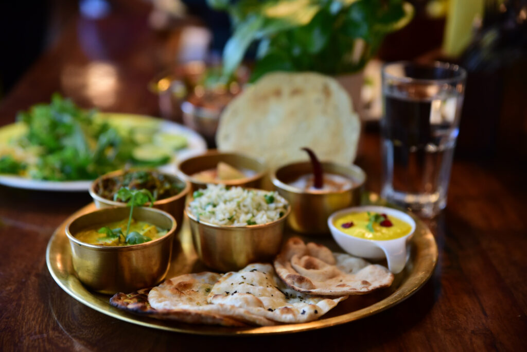 Indian Thali dish with a variety of delicious dishes on a stainless steel plate at Indian restaurant Taj in Berlin